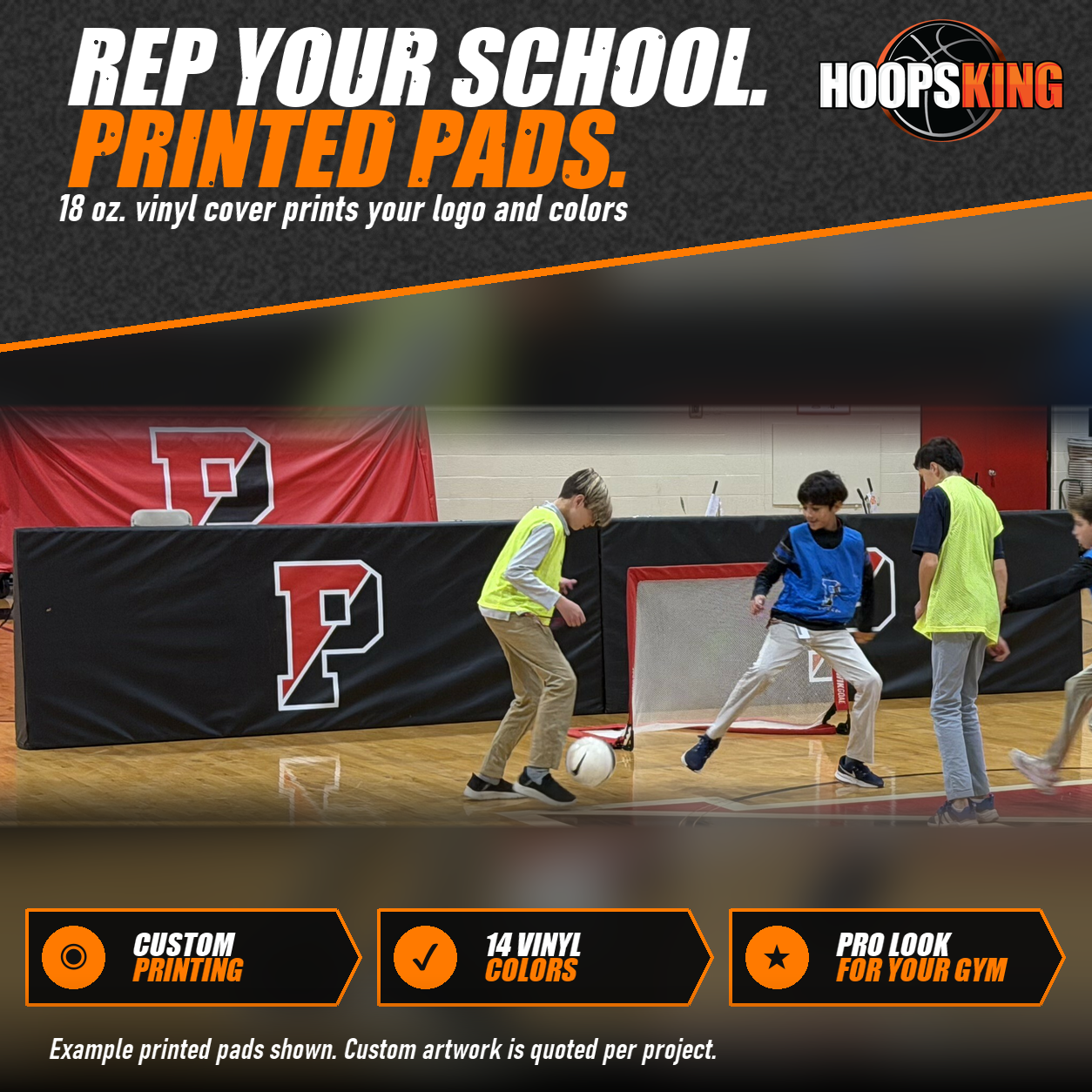 Black gym barrier pads printed with a large red and white P logo standing on a hardwood floor during soccer play