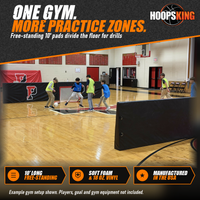 Thumbnail for Black free-standing barrier pads, some printed with a red P logo, dividing a school gym where kids play soccer