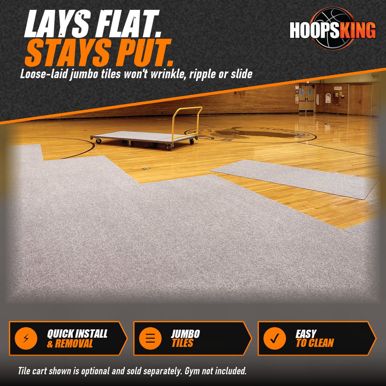 Gray GymGuard carpet tiles being laid across a hardwood basketball court with a yellow tile cart in the background