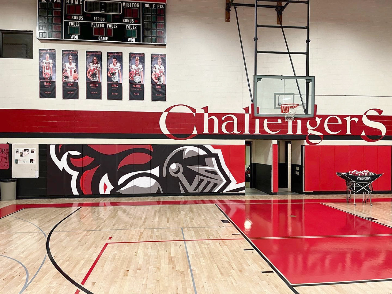 Custom printed gym wall padding mounted along a gymnasium wall to protect athletes