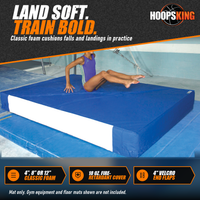 Thumbnail for Young gymnast landing seated on a thick royal blue EnviroSafe safety landing mat in a gymnastics gym
