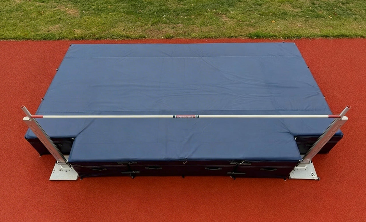 Overhead view of a high jump landing mat with standards and bar set up on a track and field runway.