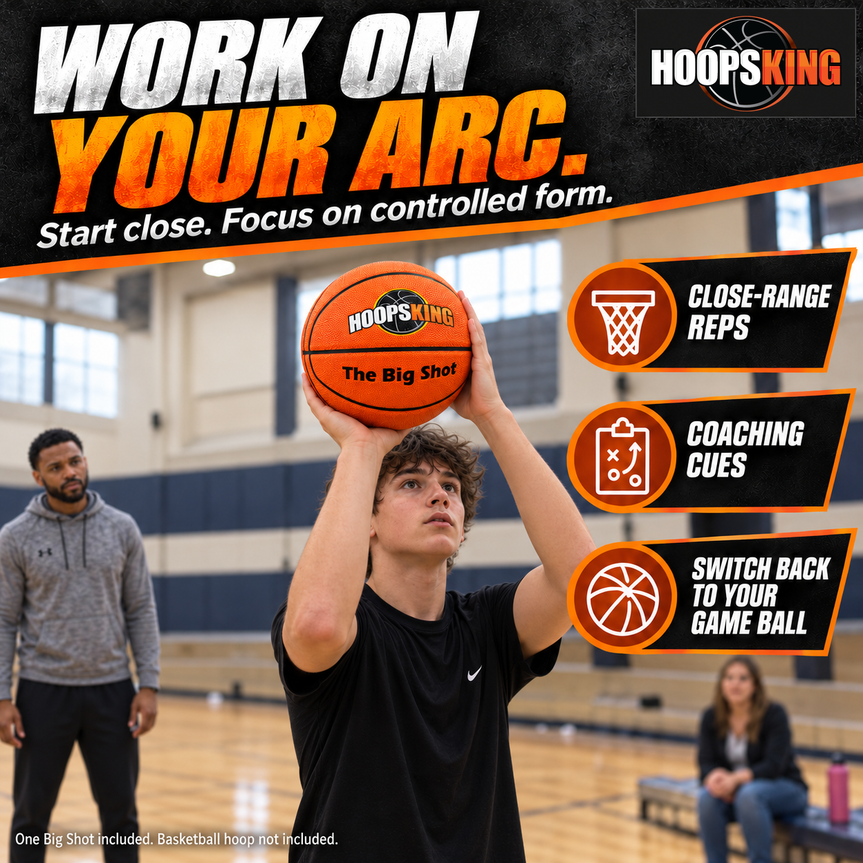 Youth athlete practices a right-handed Big Shot shooting setup with shooting hand beneath the ball and guide hand on its side; trainer observes from several feet away and parent watches from a bench