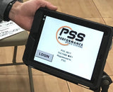 Hand holding a tablet displaying the PSS Performance Sports Systems logo and a login screen.