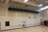 Green mat storage system suspended from ceiling in a gym with ballet barres and dancers.