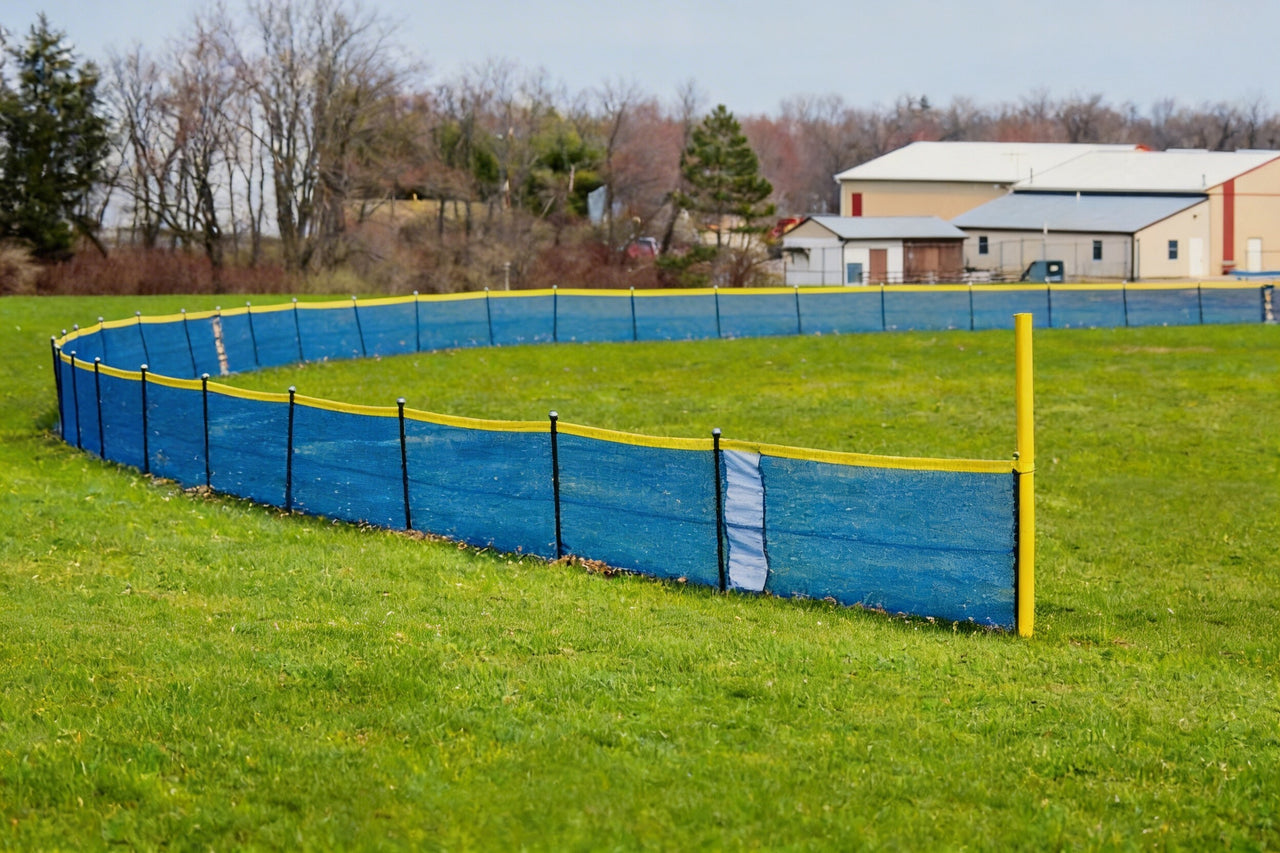 Blue In Ground Grand Slam outfield fencing with yellow foul pole kit installed along a little league baseball field boundary