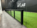 Xt Indoor batting cage kit with black custom rail padding and wall padding installed at STL Hit Lab training facility