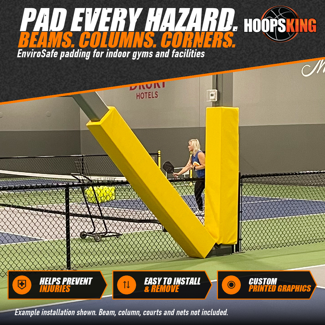 Yellow padding wrapped around an angled steel beam and an upright column beside indoor pickleball courts