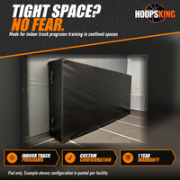 Thumbnail for Black extra-thick indoor track crash pad with side carry handles standing upright against a gray padded wall
