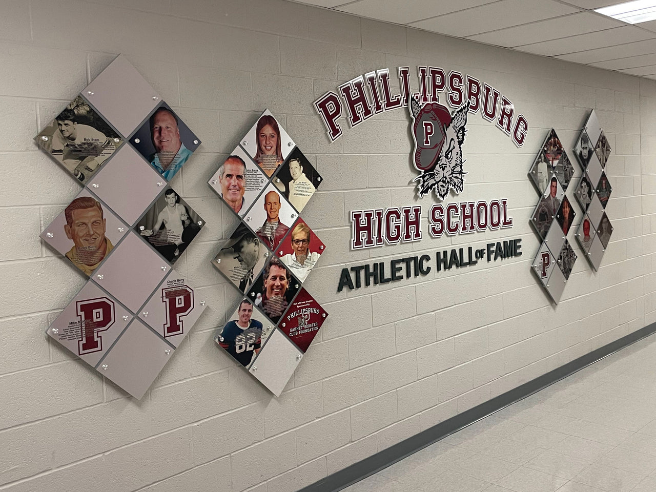 Phillipsburg High School Athletic Hall of Fame record board with diamond photo plaques and maroon P logos