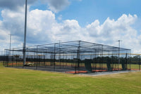 Thumbnail for Multi-lane outdoor batting cage system with steel frame and netting installed at a baseball complex with batting cage backdrops