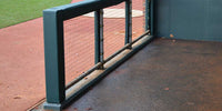 Thumbnail for Green permanent corner cover sealed around the end post of a dugout rail