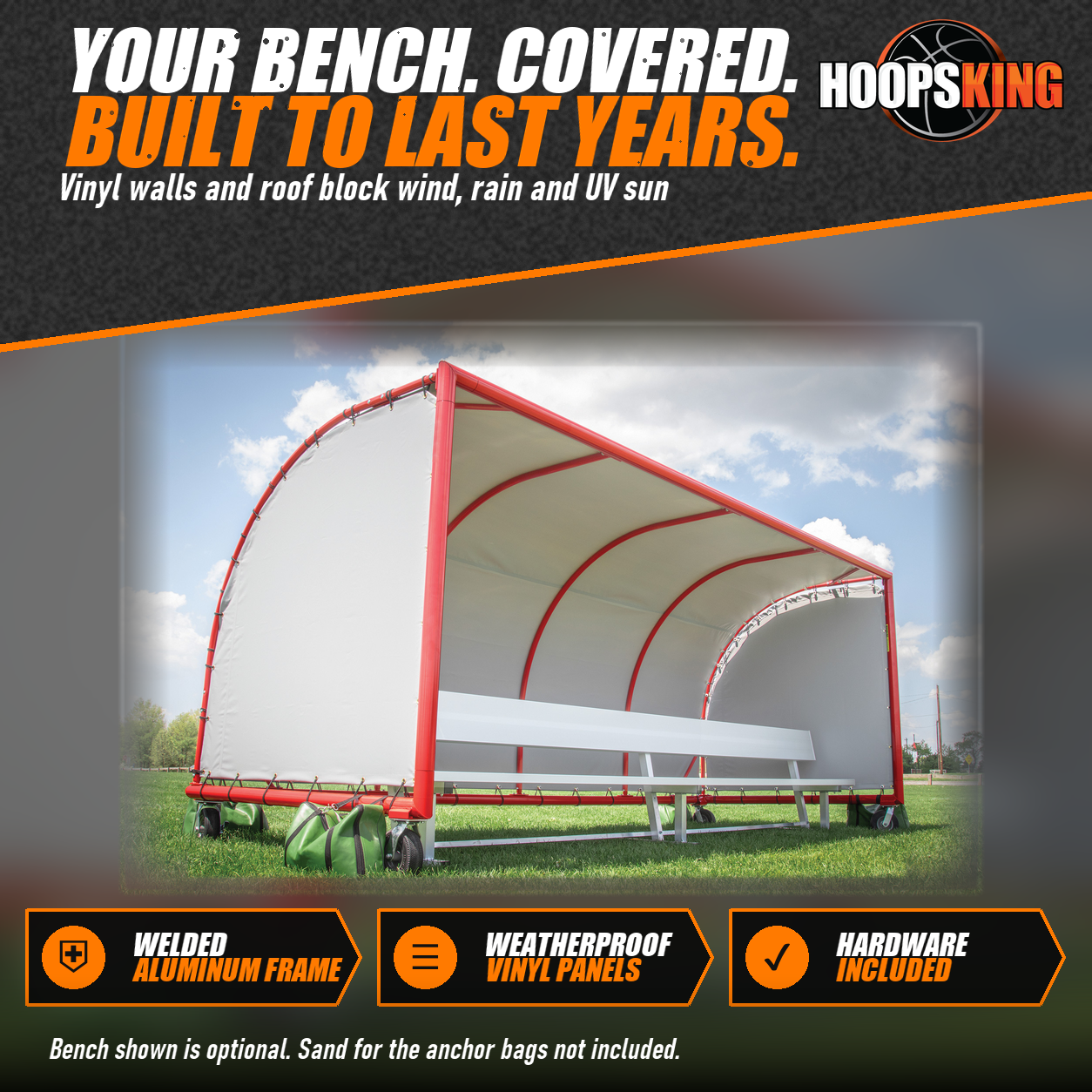 Portable team shelter with a red aluminum frame, white vinyl roof and side walls, a bench inside and green anchor bags on grass