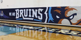 Digitally printed wall panel with "WE ARE BRUINS" text and a bear mascot design in a gym.