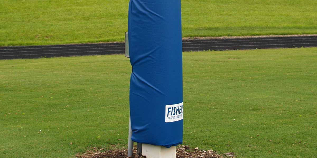 Blue wrap-type goal post pad with "FISHER" logo on a grassy field.