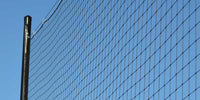 Thumbnail for Black netting attached to a pole against a clear blue sky.