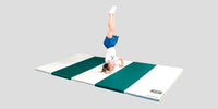 Thumbnail for Child doing a handstand on a white and green striped folding foam mat.