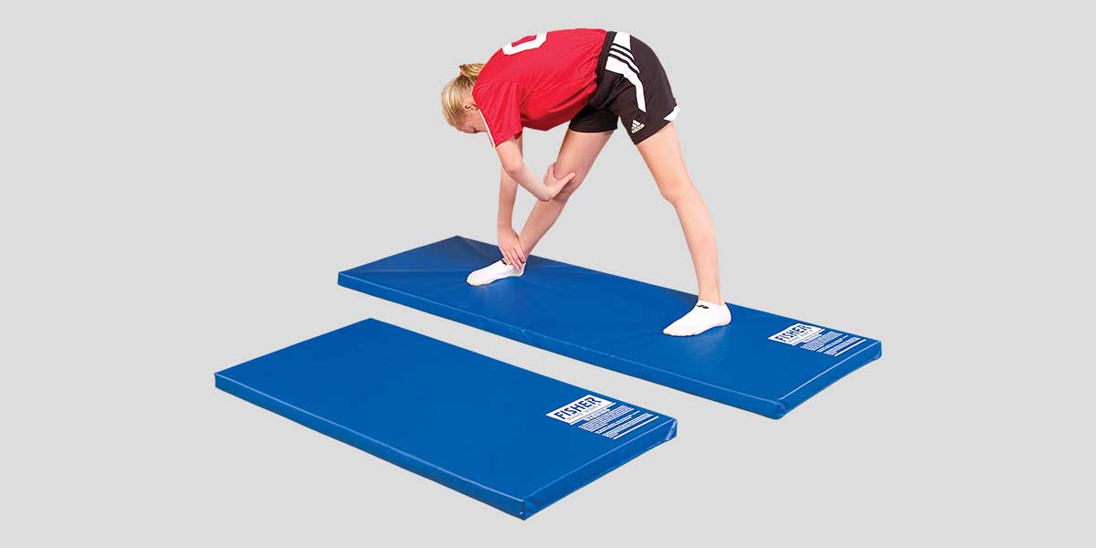Woman stretching on a blue non-folding personal mat, with another mat below.
