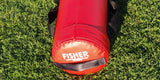Red cylindrical football tackling dummy with "FISHER" logo on green grass.