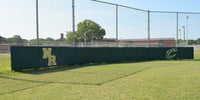 Thumbnail for Green wall panels with "NR" and "C" logos installed along a chain-link fence on a baseball field.