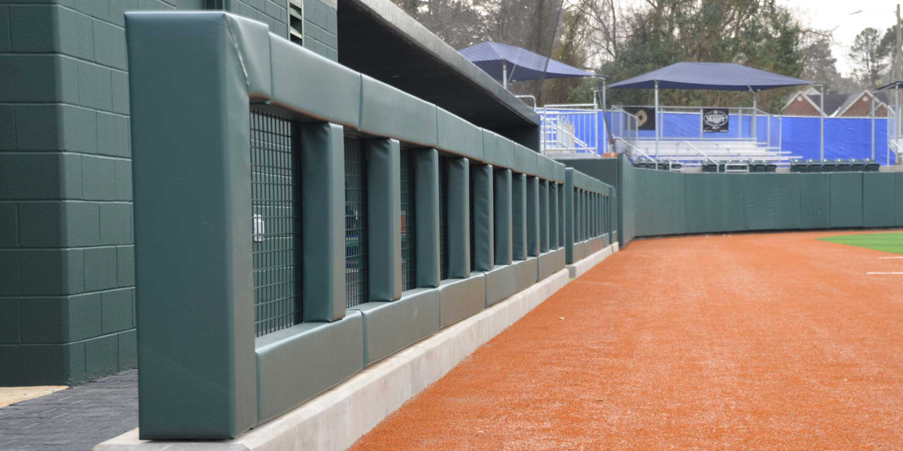Green square rail padding framing the openings of a dugout wall