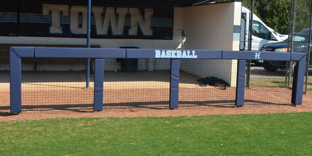 Navy square rail padding printed with Baseball across the top rail of a dugout