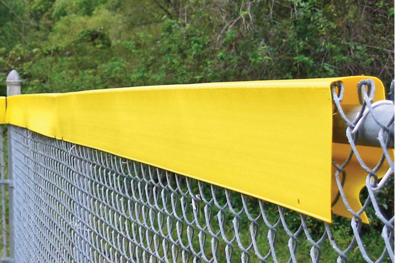 Yellow Safety Top Cap molded cap installed along the top of an outfield chain-link fence