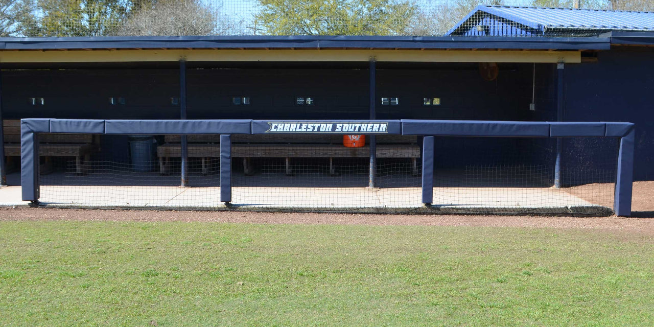 Navy square rail padding printed with Charleston Southern on a dugout rail