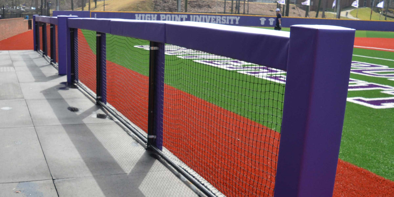 Close view of purple square rail padding covering a dugout rail and its upright posts