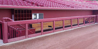 Thumbnail for Maroon square rail padding on a stadium dugout rail and posts
