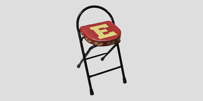 Red folding stool with a gold "E" on the seat and a black frame.