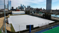 Thumbnail for Aerial view of Rhodes Field at the University of Pennsylvania showing a CoverSports growth cover fully deployed across the soccer field in winter, with the Philadelphia skyline including the Comcast Center and PMC Tower visible in the background