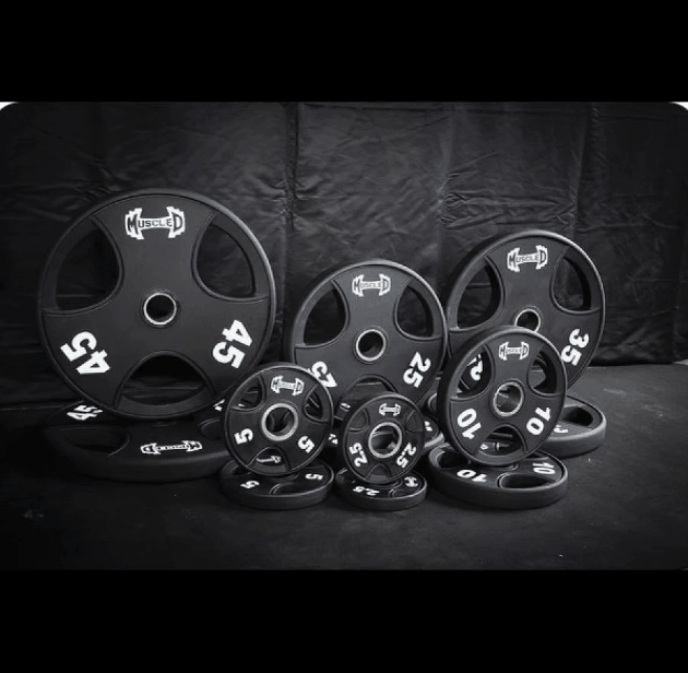 Black urethane Olympic weight plates in various sizes (2.5, 5, 10, 25, 35, 45 lbs).