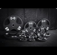 Thumbnail for Black urethane Olympic weight plates in various sizes (2.5, 5, 10, 25, 35, 45 lbs).