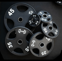 Thumbnail for Black Olympic weight plates in various sizes (2.5, 5, 10, 25, 35, 45 lbs) with 