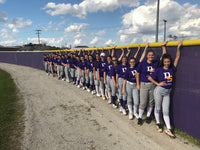 Thumbnail for High school girls' softball team lined up against the outfield fence windscreen