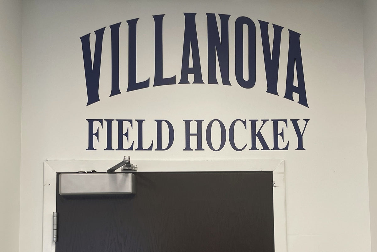 Custom vinyl wall graphics for Villanova Field Hockey displayed above a locker room door