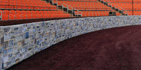 Thumbnail for Backstop padding printed with a stone wall graphic curving behind home plate