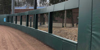Thumbnail for Green wall padding panels installed along the base of a fence line with matching padded posts