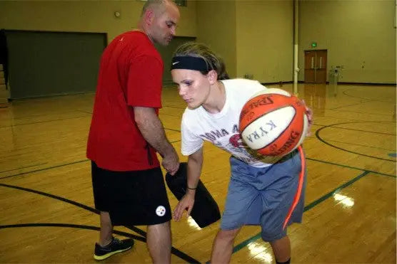 Here we are teaching the driver to knock away the pad to simulate the defense reaching in.  Hit the defender's arm and leave them in the dust.