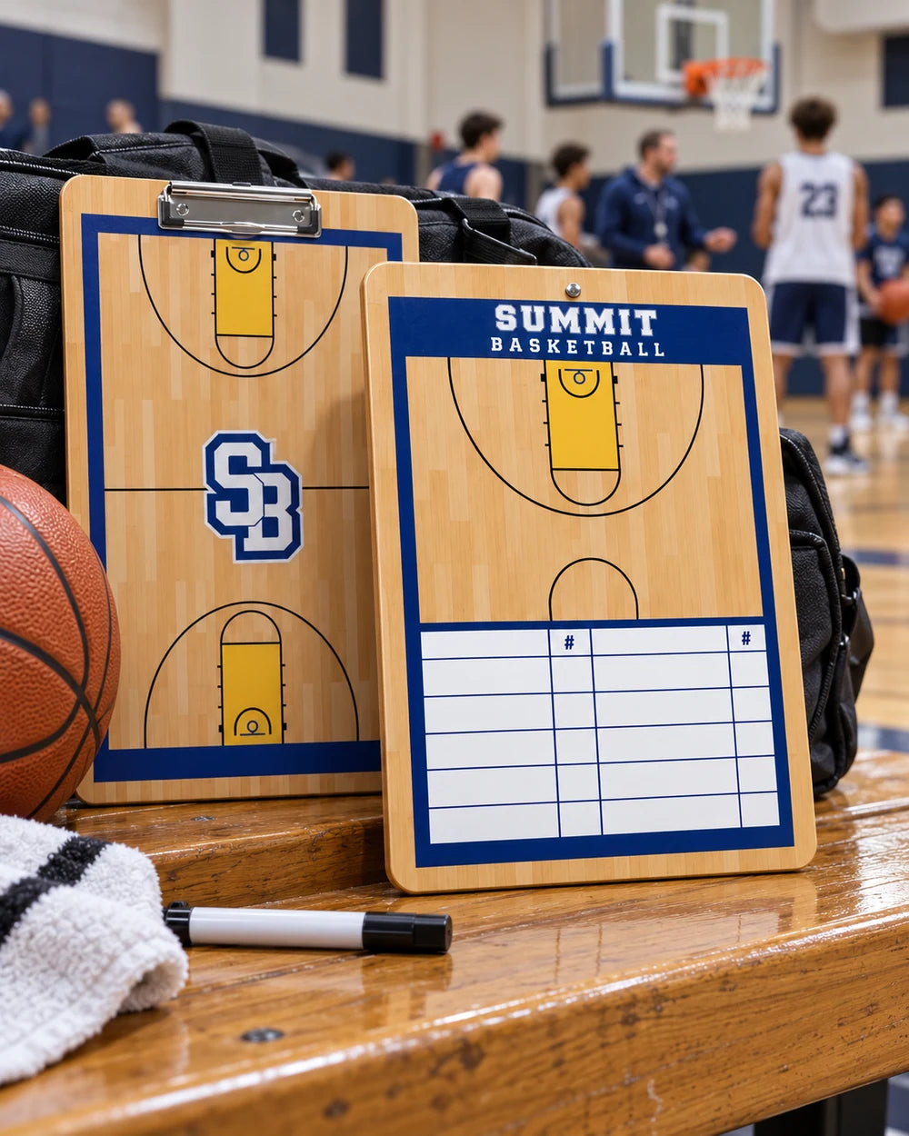 Matching Summit Basketball lineup clipboards showing a full-court front and half-court with player grid on the back at a school gym bench