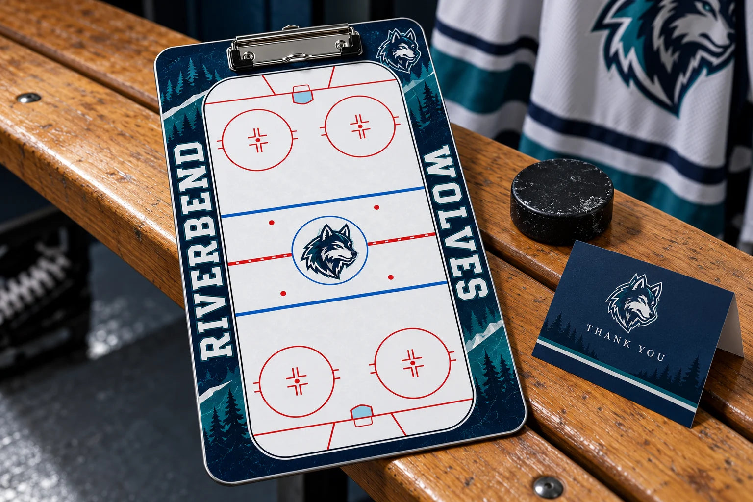 Illustrative navy and teal Riverbend Wolves hockey clipboard beside a puck and team thank-you card